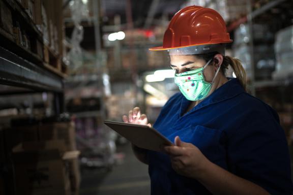 Warehouse worker wears face mask during pandemic