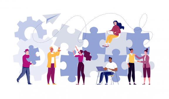 Illustration of group working together building puzzle pieces