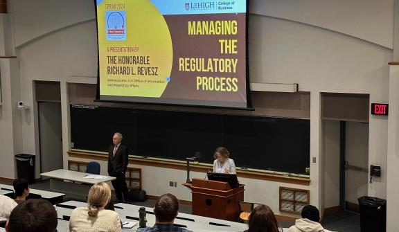 Georgette Chapman Phillips, the Kevin L. and Lisa A. Clayton Dean of College of Business, introduces Richard Revesz, Administrator of of the U.S. Office of Management and Budget's Office of Information and Regulatory Affairs.