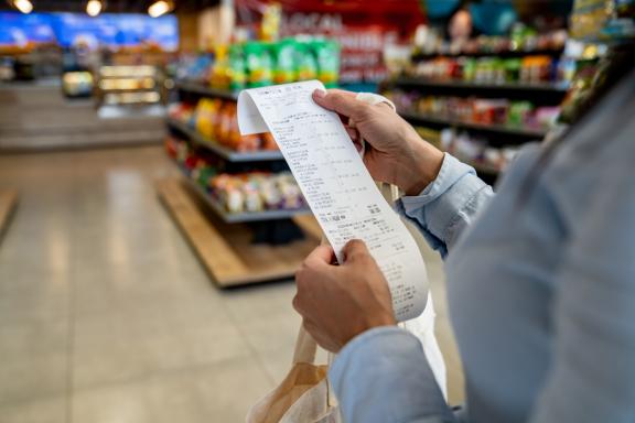 person checking a receipt in a store