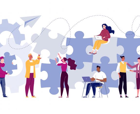 Illustration of group working together building puzzle pieces