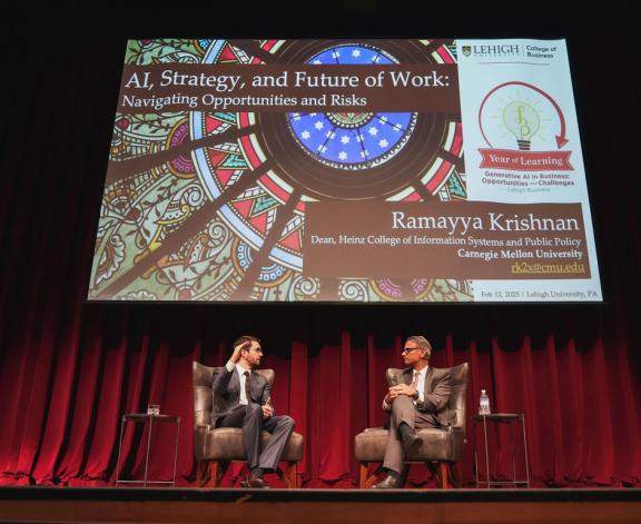 Burak Eskici, a teaching assistant professor in Lehigh College of Business' DATA Department, and featured speaker Ramayya Krishnan, right, at the 2025 Year of Learning lecture.