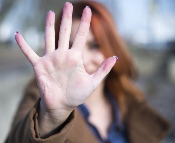 person with hand up