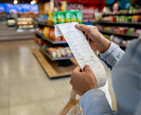 person checking a receipt in a store
