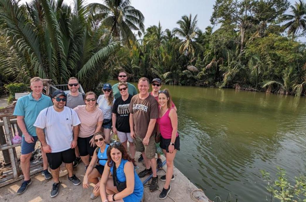 Students posing in group near Mekong Delta. 