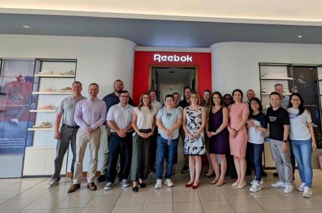 Students posing with Reebok executives on global immersion trip in Vietnam.