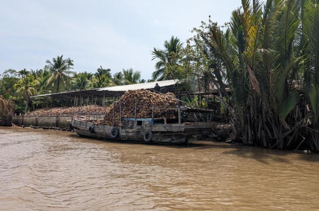 Boat on river carrying goods. 